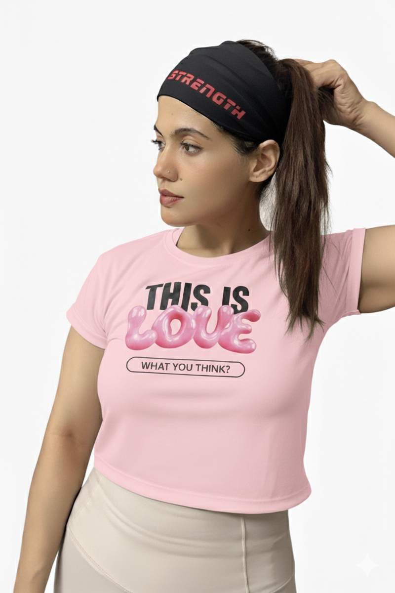 Woman wearing a pink t-shirt with text and a black headband with red text on a white background